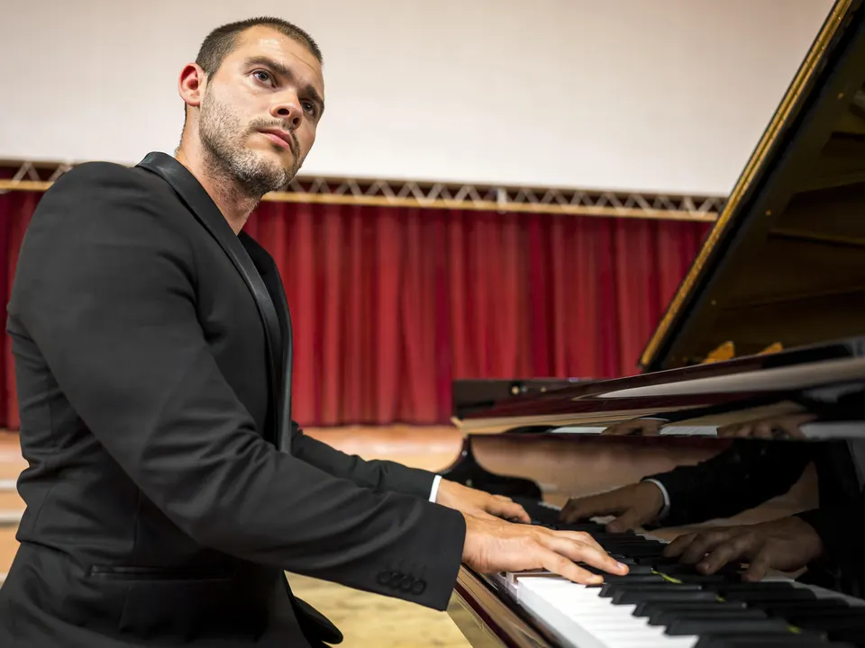 Pianist performing on a concert stage
